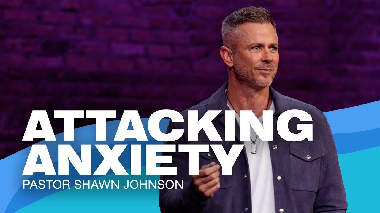 Pastor Shawn Johnson standing with his right arm at his side looking out.